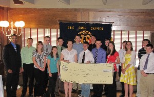 Richard Lockridge (l), chapter president, presents scholarship awards to students at the June luncheon.